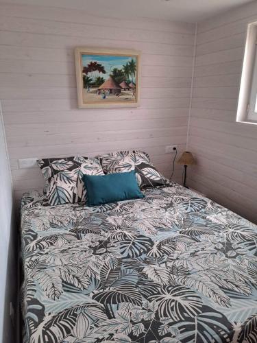 - un lit avec une couette et des oreillers dans une chambre dans l'établissement Gruissan chalet authentique 50m de la plage, à Gruissan