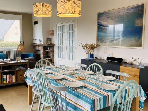 une salle à manger avec une table et des chaises bleues dans l'établissement Maison spacieuse, plage à 200m, Trégastel - FR-1-542-6, à Trégastel
