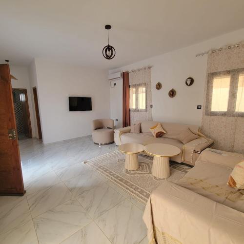 a living room with a couch and a table at Villa Banati in Djerba