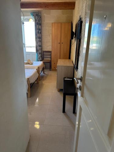 a hallway with two beds and a door to a room at 71 San Antonio in Victoria