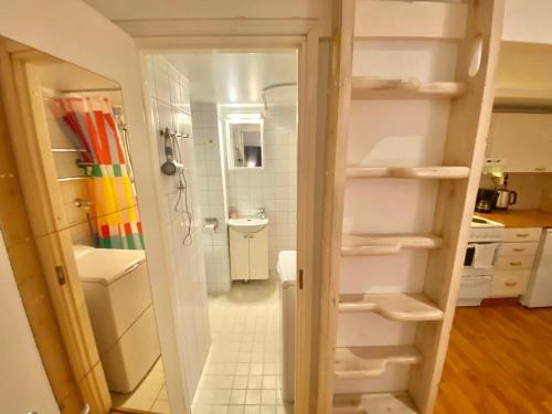 a bathroom with a walk in shower and a sink at Pink Gem, Kamppi in Helsinki