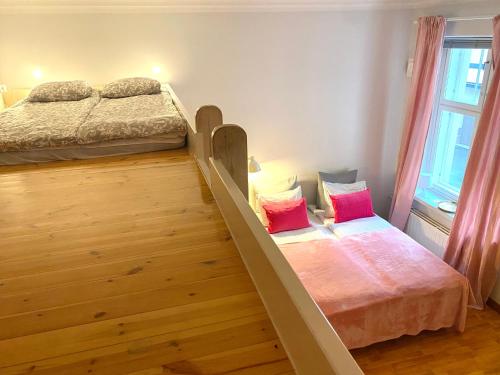two beds in a room with a bunk bed at Pink Gem, Kamppi in Helsinki