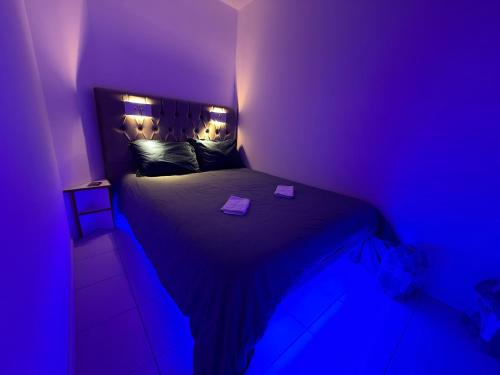 - une chambre violette avec un lit et 2 boîtes dans l'établissement EXCEPTIONNEL sur CANNES vue mer piscine, à Cannes