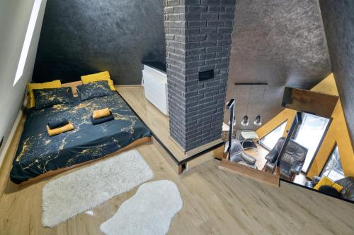 an overhead view of a bedroom with a bed and a brick wall at Diamond Hill Veselić in Divčibare