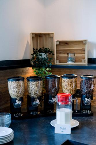 a group of four glass containers filled with rice at Trip Inn Hotel Dasing-Augsburg in Dasing