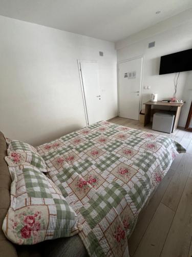 a bedroom with a bed with a quilt on it at Villa Marina in Ohrid