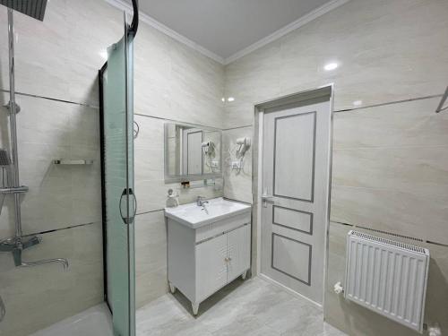 a bathroom with a sink and a shower at Anor Qal'a in Khiva