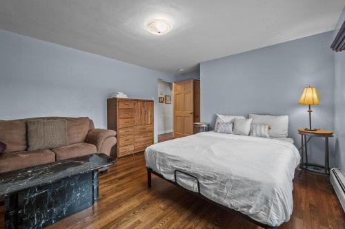 a bedroom with a bed and a couch at 180 S Hoyt in Lakewood