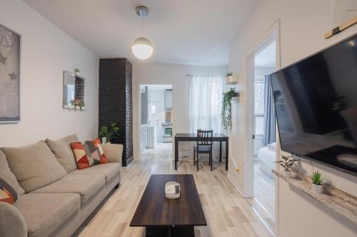 a living room with a couch and a table at Excellent 4 Bedroom in Griffintown Downtown MTL in Montréal