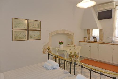 a bedroom with a bed and a kitchen at Pension Eva in Chania Town