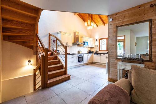 a kitchen with a spiral staircase in a room at Chalet Abricotine, sleeps 10, Hot tub in Saint-Jean-dʼAulps