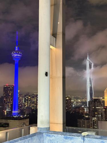 a view of the space needle at night at The Luxe Colony Klcc By NTR Resources in Kuala Lumpur