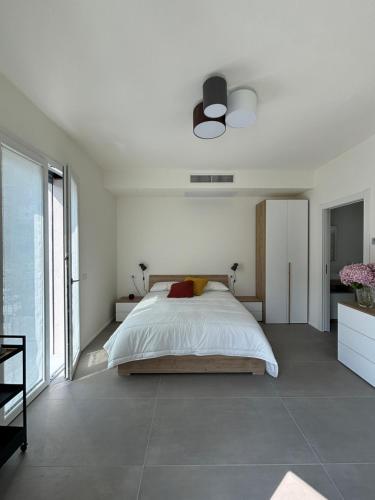 a bedroom with a bed and a large window at Il Giardino Segreto in Faggeto Lario 