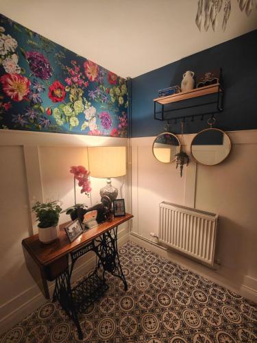 a room with a table and a painting on the wall at Teach Baile í nDún Geimhin in Dungiven