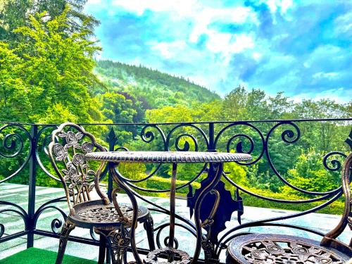 a wrought iron table and chairs on a balcony at VILLA FIRST im Sophienhof in Königswinter