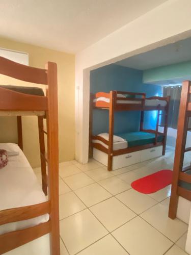 a room with two bunk beds and a bathroom at Apraiana Pousada e Hostel in Recife