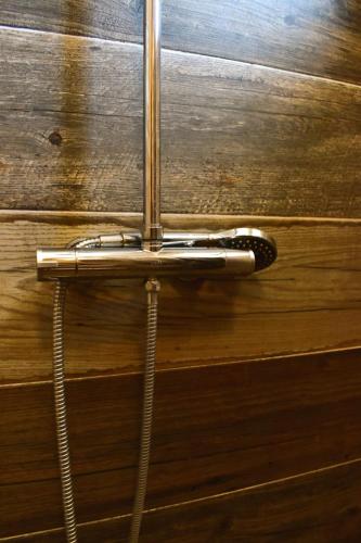 a metal door handle on a wooden wall at Oguic apartman in Pag