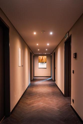 an empty hallway with a painting on the wall at VILLA FIRST im Sophienhof in Königswinter