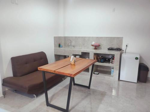 a kitchen with a table and a chair and a sink at Studio del Centro in Huajuapan de León