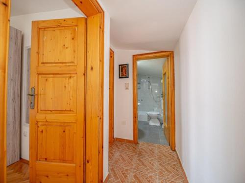 a hallway with a bathroom with a toilet and a door at Villa Yovan Seaview in Dobra Voda