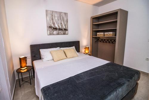 a bedroom with a large bed and a closet at Black Diamond in Novalja