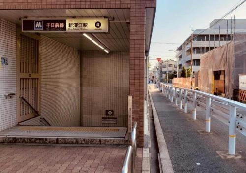 an entrance to a building with a sign on it at Santana Guest House Osaka in Osaka