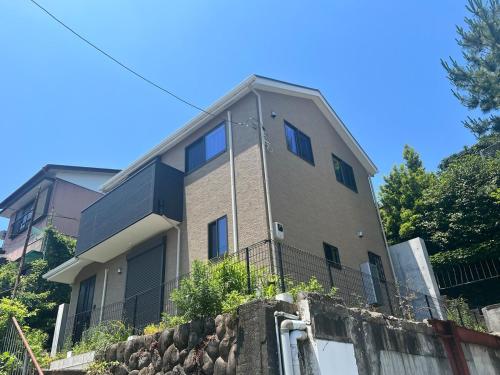 a building on top of a stone wall at FabulousOdawara in Odawara