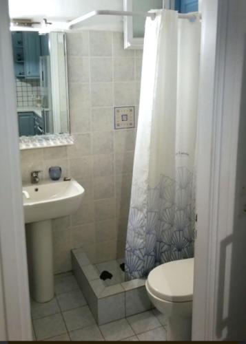 a bathroom with a sink and a toilet and a shower at Maridina House in Livadi