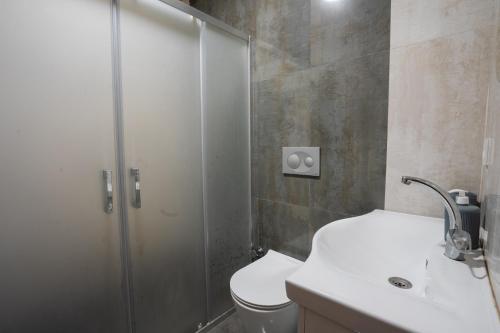 a bathroom with a shower and a toilet and a sink at Sora No Mori Village in Marmaris