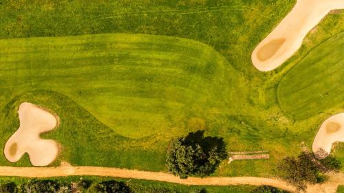 an overhead view of a green golf course at Luce di Mare, Vista Mare Sea View in Is Molas 