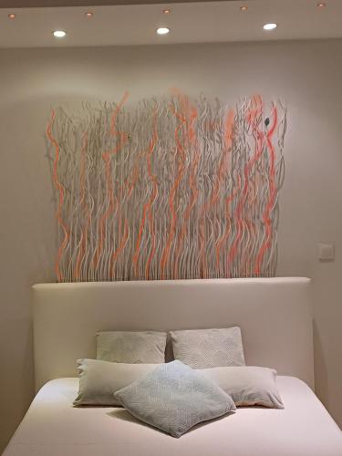 une peinture sur un mur au-dessus d'un lit dans l'établissement Le cap d'agde quartier naturiste Héliopolis E, au Cap d'Agde