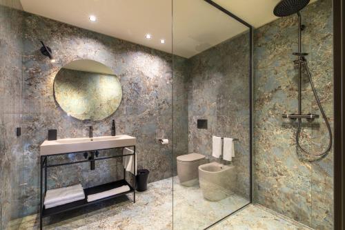 a bathroom with a shower and a sink and a mirror at Palazzo CarpeDiem-Prato della Valle in Padova