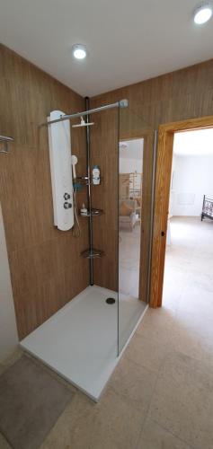 a shower with a glass door in a room at La Vista Secreta in Oria