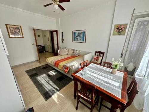 a bedroom with a bed and a dining room table at Madi house Ciampino in Ciampino