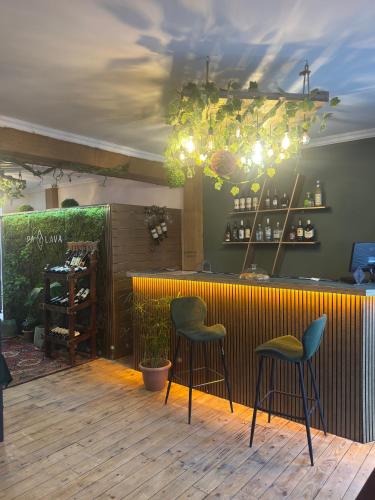 a bar with two stools in front at Paxlava Dilijan Guesthouse & Restaurant in Dilijan