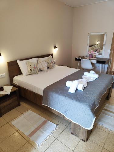 a bedroom with a bed with towels on it at YANNA Studios & Apartments in Tsilivi