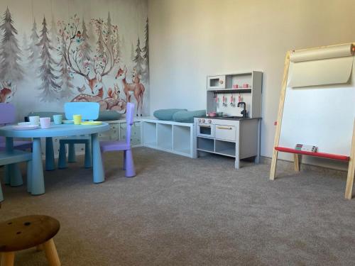 a room with a childs room with a table and chairs at Willa Podhalanka Jacuzzi & sauna - drewniany dom dla 20 osób in Biały Dunajec