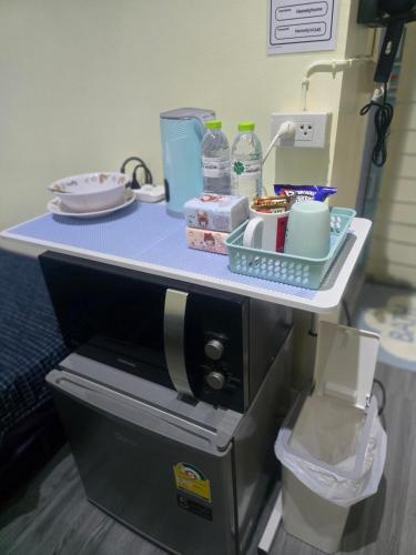 a table with a counter top with a coffee maker at 209 Cozy apartment with nice fan near skytrain & WiFi in Bangkok