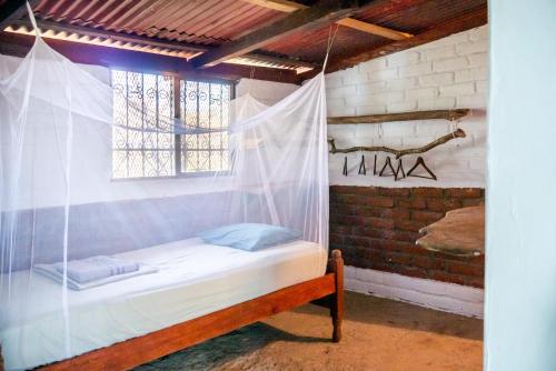 a bed in a room with a mosquito net at Casa Medusa in El Gigante