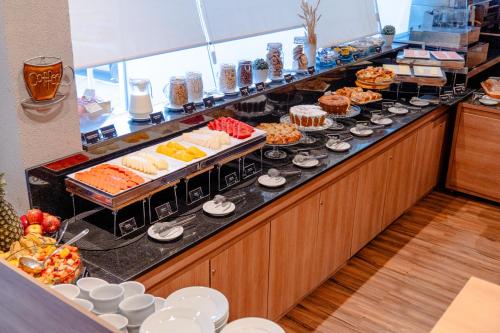 a buffet line with many different types of food at i5 Hotel Águas Claras in Brasilia