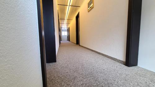 a corridor of a building with a hallwayngth at Hotel Cafe Seeblick in Filzbach