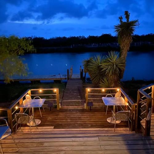 a wooden bridge over a lake at night at Rocket Ranch #4 - Venus in Brownsville