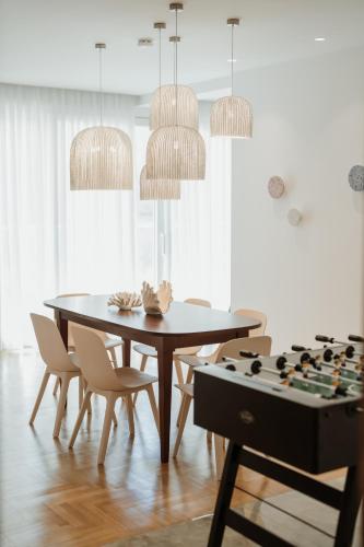 a dining room with a table and a chessboard at iKu Urban Apartment in Kavála