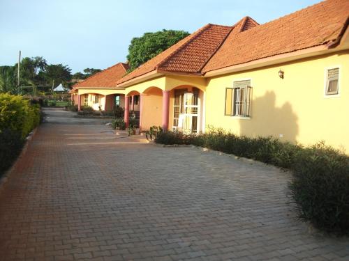 a row of houses on a brick road at Peniel Beach Hotel in Entebbe