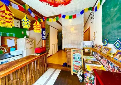 a room with a classroom with flags on the ceiling at Santana Guest House Osaka in Osaka