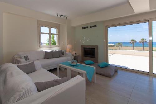 a living room with a couch and a fireplace at Villa Eco Blu in Marathopolis