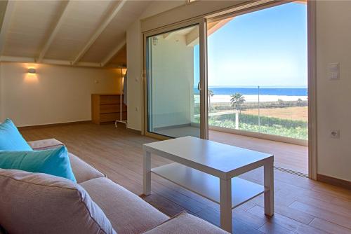 a living room with a couch and a table at Villa Eco Blu in Marathopolis