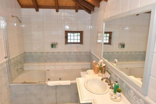 a bathroom with a tub and a sink and a mirror at Casa Haydee in Ciudad Lujan de Cuyo