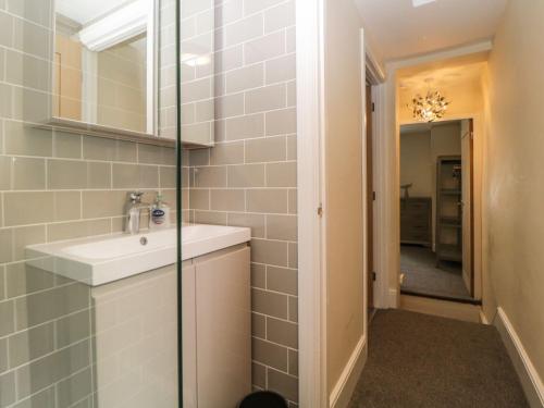 a bathroom with a sink and a mirror at Harbour Cottage in Torquay