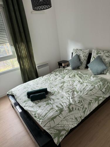 - une chambre avec un lit et une couette verte et blanche dans l'établissement Appartement, Cozy trois, à Toulouse